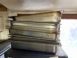 several pans stacked on top of each other in a kitchen