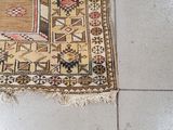 a rug on the floor with a cat laying on top of it
