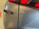 a close up of a car ' s tail light with a sticker on it