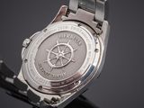 a close up of a watch on a black surface