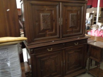 a wooden cabinet that is in the middle of a room