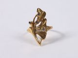 a close up of a gold ring on a white surface