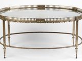an antique brass coffee table with a glass top on a white background