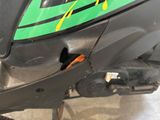 a close up of a motorcycle with a green and yellow decal