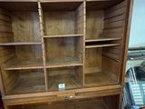 a wooden bookcase with many shelves in it