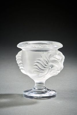 a clear glass vase with a flower design on it