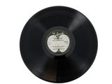 an old vinyl record on a white surface with a white background