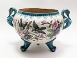a blue and white vase with a bird on it