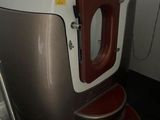 une baignoire avec un siège rouge dans une salle de bains