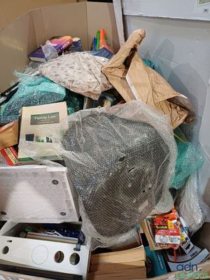 a cardboard box filled with assorted items on the floor
