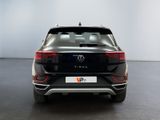 the rear end of a black volkswagen suv parked in a showroom