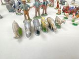 many figurines of people and animals on the table