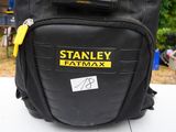 a black bag with yellow handles sitting on top of a table