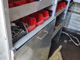 many shelves with red buckets on them in a room
