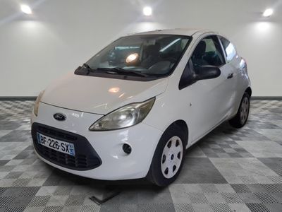 a picture of a small white car parked in a garage