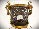a gold metal planter with a price tag on it