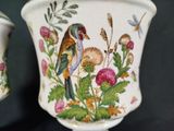 two vases that are decorated with birds and flowers