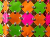 an orange, green, and pink bag with a pattern on it