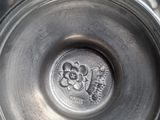 a close up of a metal object with a flower on it