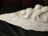a white sculpture on a black cloth on a table