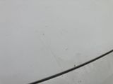 someone is cleaning the hood of a white car with a rag