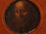 portrait of a man with a beard in a round wooden frame