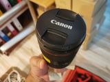 a person holding a camera lens in their hand