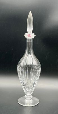 a clear glass bottle with a glass stopper on it