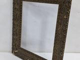 an old wooden frame with a decorative pattern on it