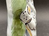 a figurine of a woman in a green and white dress