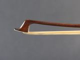 a close up of a violin bow on a gray background