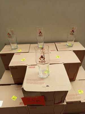 many boxes of wine glasses sitting on top of each other
