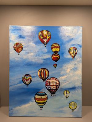 tableau représentant un groupe de montgolfières volant dans le ciel