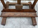 a wooden table with a wooden top on a sidewalk