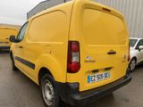 a yellow van that is parked in a parking lot