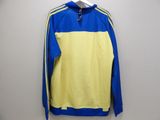 a yellow and blue sweatshirt hanging on a wall