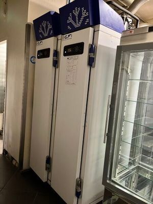 several refrigerators are lined up in a row in a room