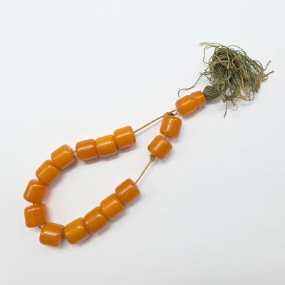 an orange bead with a string attached to it