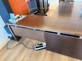 a wooden desk with a laptop on top of it