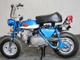 a small blue motorcycle parked in a garage