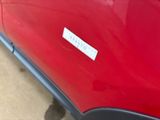 a red car with a sticker on the side of it