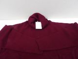 a close up of a red sweater with a white tag on it