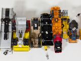 a lot of toy vehicles that are lined up on the wall