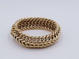 a gold bracelet with a braid design