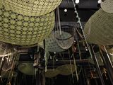 many baskets hanging from the ceiling of a restaurant