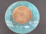a blue and brown plate with a drawing on it