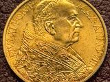 a close up of a gold coin with a man ' s face on it