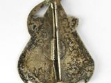an image of a brooch or badge of a violin player