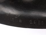 a close up of a black sculpture on a white surface