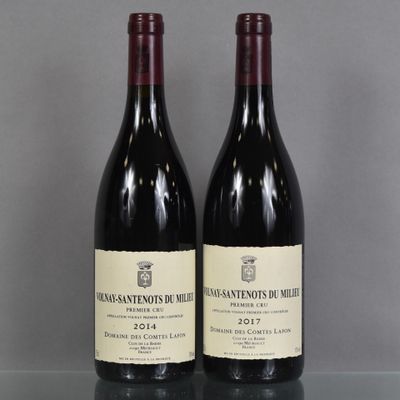 two bottles of wine sitting on top of a table next to each other
